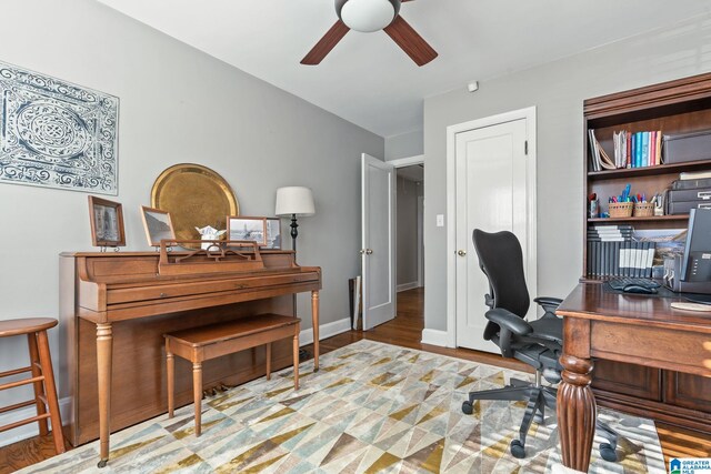 home office featuring light hardwood / wood-style flooring and ceiling fan