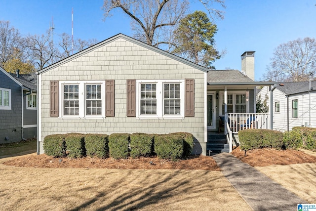 view of front of house with a porch and a front lawn