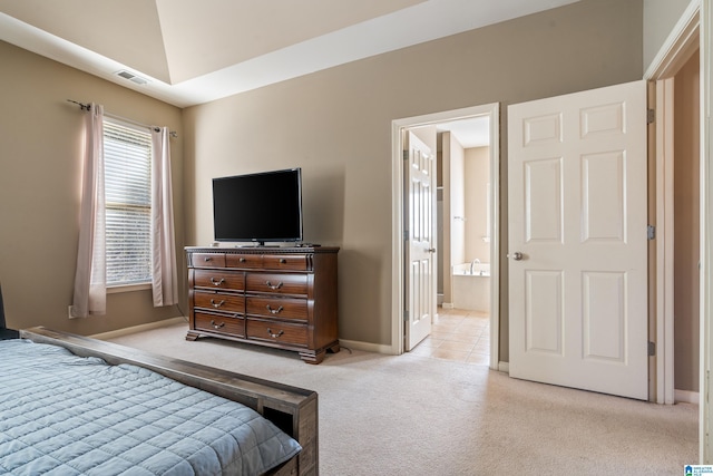 bedroom with light carpet, connected bathroom, and lofted ceiling