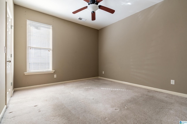 carpeted empty room featuring ceiling fan