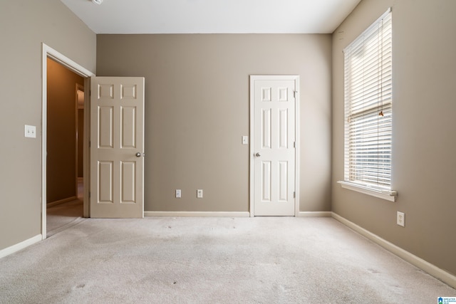 unfurnished room with light colored carpet