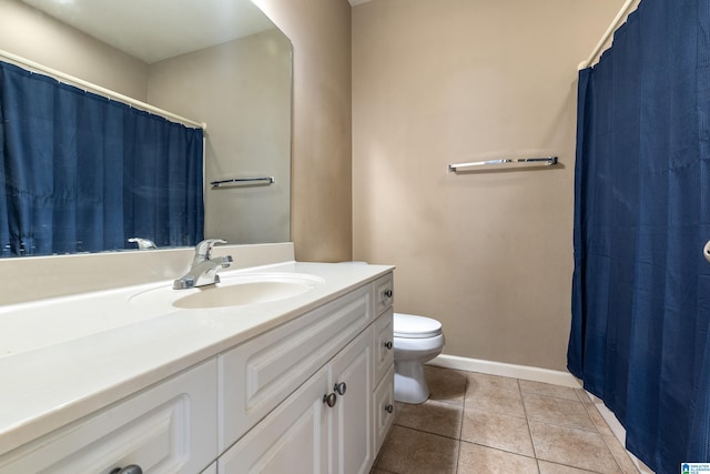 bathroom featuring vanity, tile patterned floors, and toilet