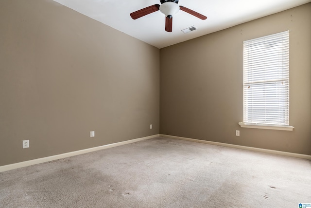 carpeted empty room featuring ceiling fan