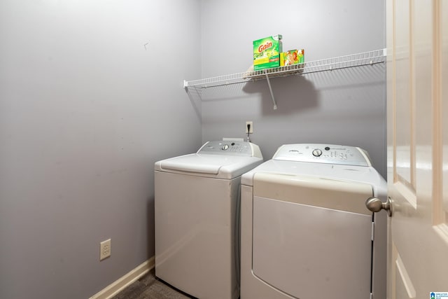 clothes washing area with washing machine and dryer