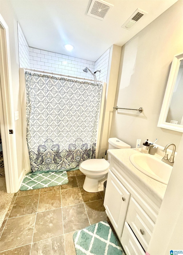 bathroom with toilet, vanity, and walk in shower