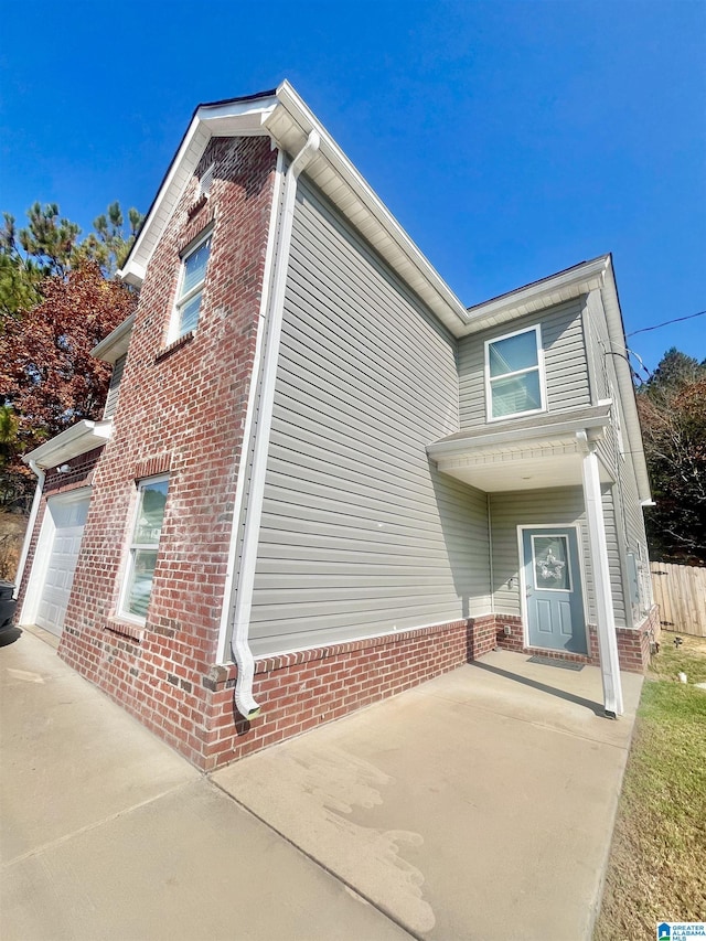 view of side of property with a garage