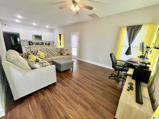 living room with ceiling fan and dark hardwood / wood-style floors