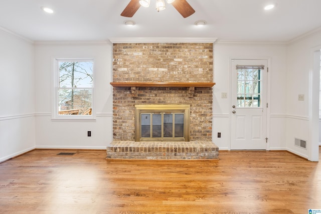 unfurnished living room with ornamental molding and visible vents