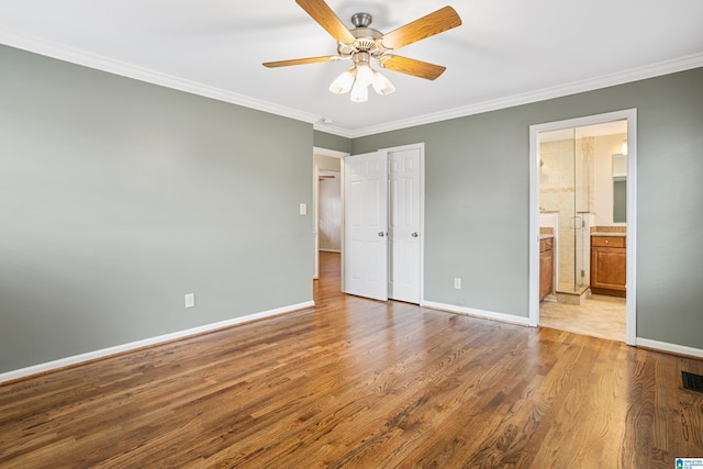 unfurnished bedroom featuring a ceiling fan, light wood-type flooring, crown molding, and baseboards