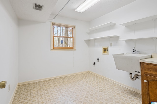 laundry room with laundry area, washer hookup, visible vents, baseboards, and light floors