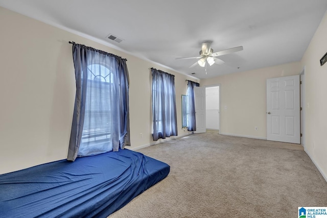 unfurnished bedroom with light carpet and ceiling fan