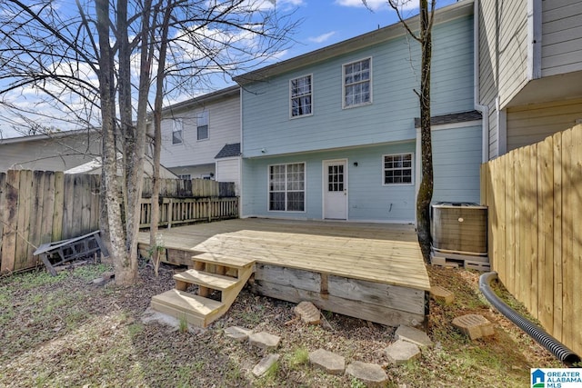 rear view of house featuring a wooden deck and central air condition unit