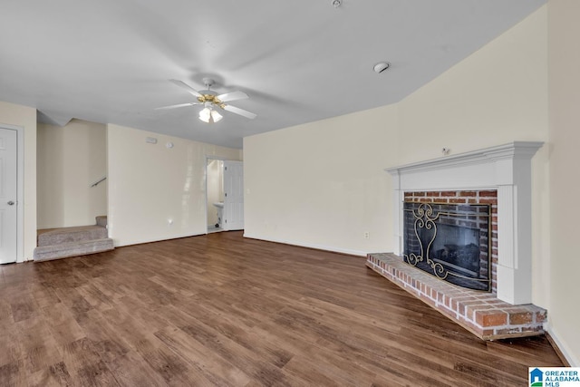 unfurnished living room featuring ceiling fan, hardwood / wood-style flooring, and a brick fireplace