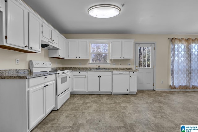 kitchen with white cabinetry, sink, white appliances, and dark stone counters