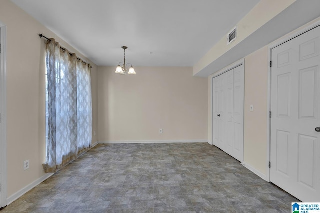 unfurnished dining area featuring a chandelier