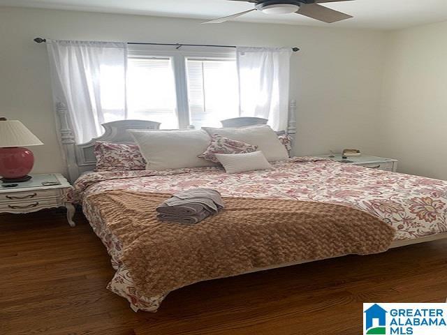 bedroom with dark wood-type flooring and ceiling fan