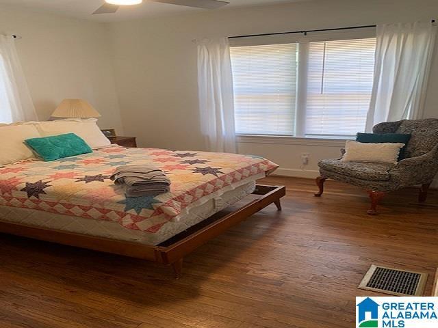 bedroom with ceiling fan and dark wood-type flooring