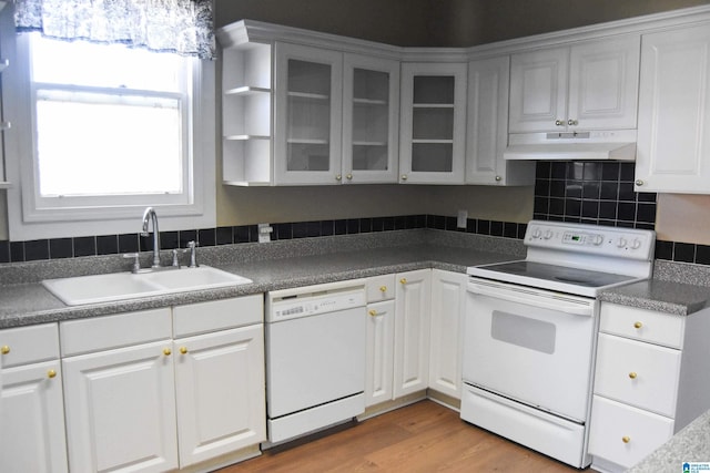 kitchen featuring white cabinetry, sink, light hardwood / wood-style floors, and white appliances