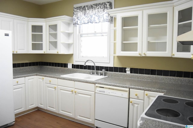 kitchen with dark wood-type flooring, sink, white appliances, and white cabinets