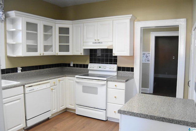 kitchen with white appliances, white cabinets, and light wood-type flooring