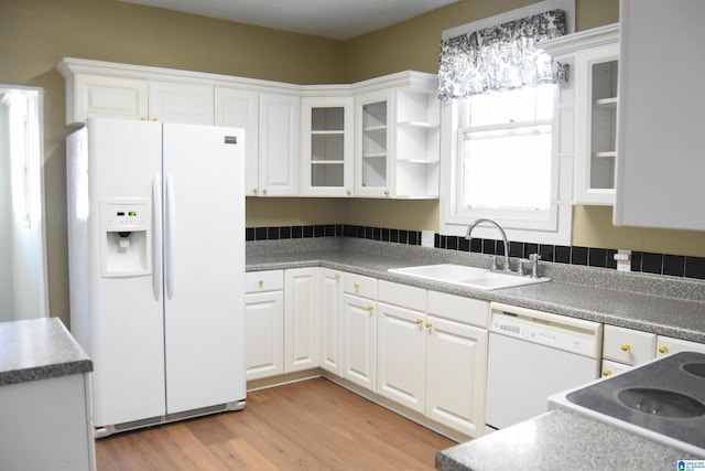 kitchen with sink, white appliances, white cabinetry, and light hardwood / wood-style flooring