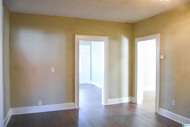 spare room featuring dark hardwood / wood-style flooring