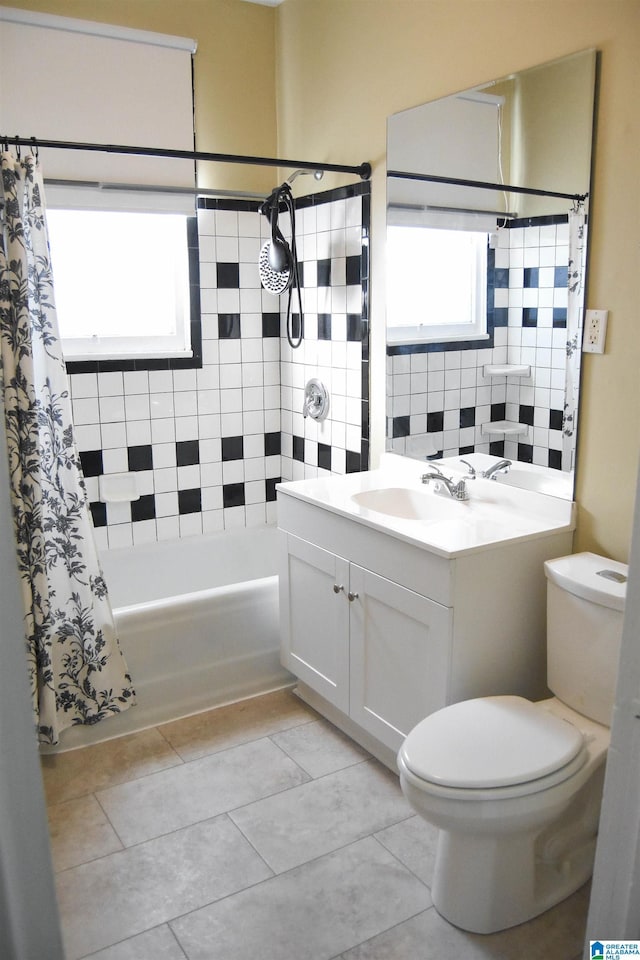 full bathroom with toilet, tile patterned flooring, vanity, and shower / bath combo with shower curtain