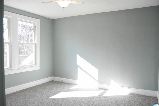 empty room with ceiling fan and carpet