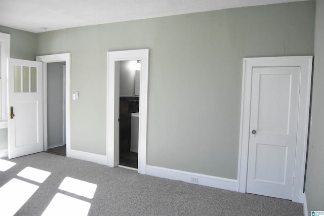 unfurnished bedroom featuring carpet floors and connected bathroom