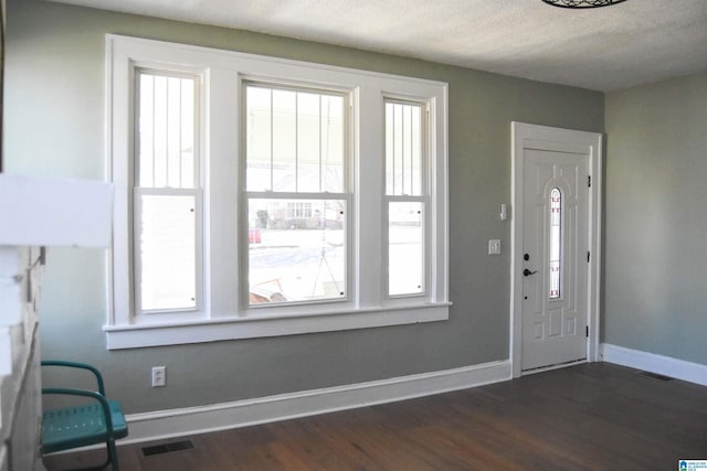 foyer featuring a textured ceiling and dark hardwood / wood-style flooring