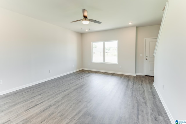 empty room featuring ceiling fan and light hardwood / wood-style floors