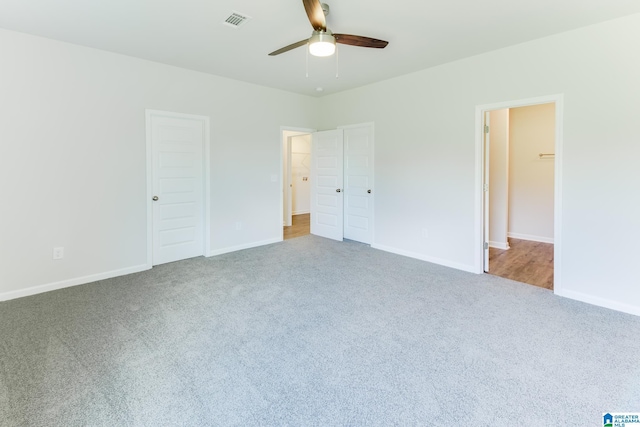 unfurnished bedroom featuring ceiling fan, a closet, and carpet floors