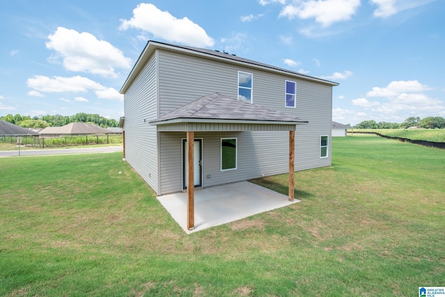 back of property featuring a lawn and a patio area