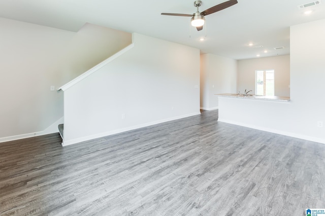 unfurnished living room with ceiling fan and hardwood / wood-style flooring