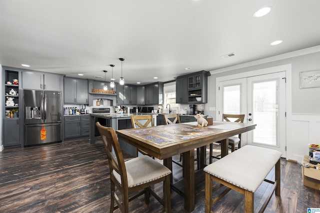 dining room with french doors, dark wood-type flooring, sink, and ornamental molding