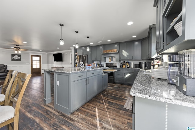 kitchen with decorative light fixtures, sink, gray cabinets, and a kitchen island