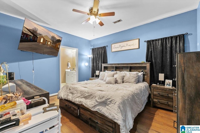 bedroom featuring ceiling fan, light hardwood / wood-style flooring, and ensuite bath