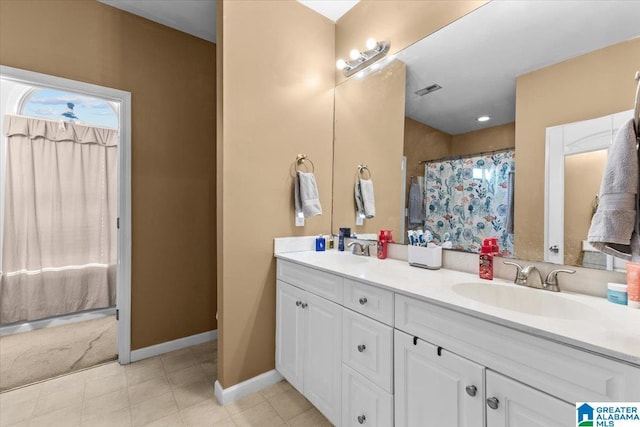 bathroom featuring vanity and a shower with shower curtain