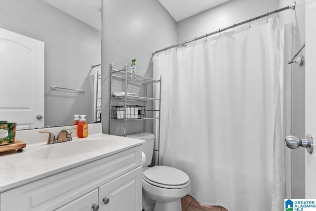 bathroom with vanity, toilet, and tile patterned floors