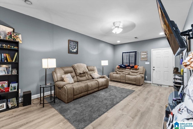 living room featuring light wood-type flooring and ceiling fan