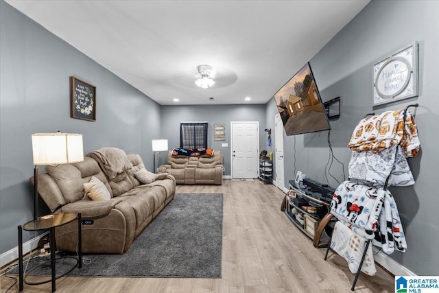 living room with ceiling fan and wood-type flooring