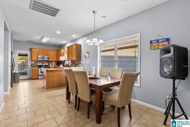 dining room featuring a notable chandelier and light tile patterned floors