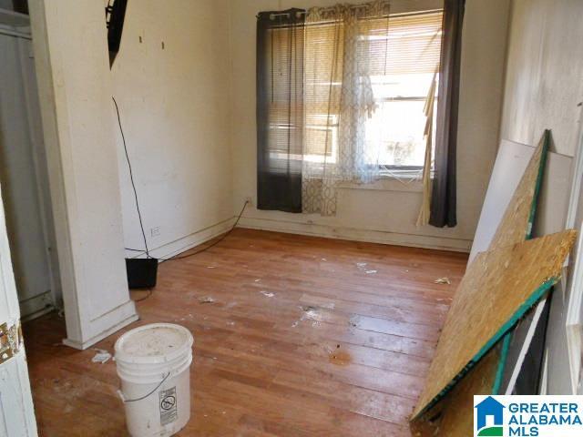 unfurnished room with wood-type flooring