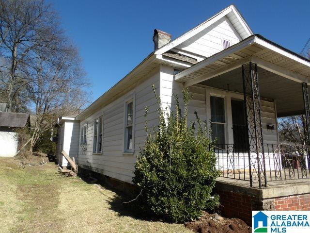 view of home's exterior featuring a lawn and a porch