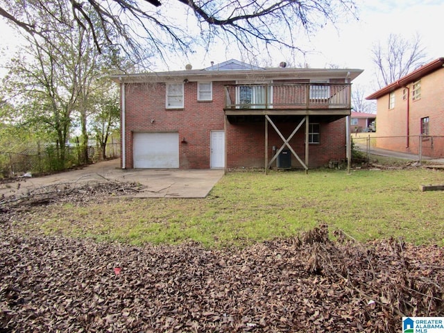 rear view of house featuring a wooden deck, central air condition unit, a yard, and a garage