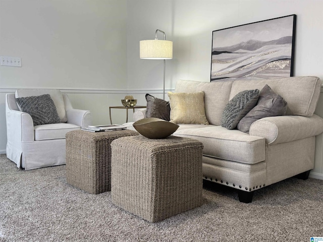 carpeted living room featuring wainscoting