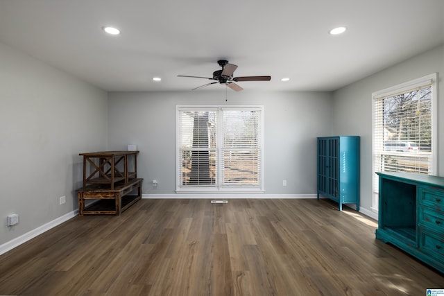 interior space with ceiling fan and dark hardwood / wood-style floors