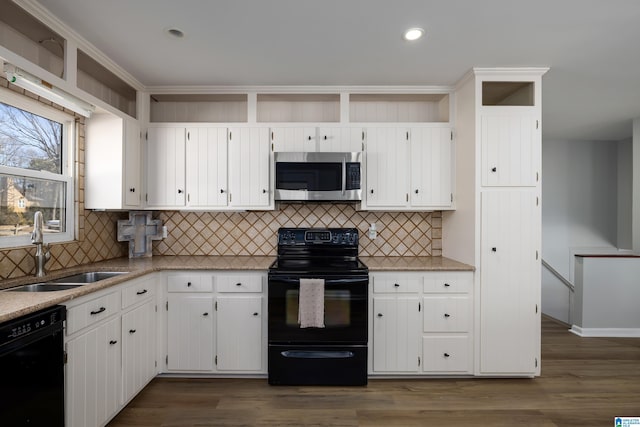 kitchen with white cabinetry, sink, and black appliances