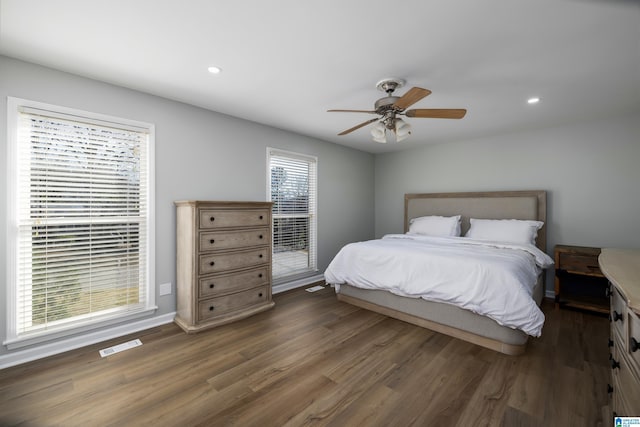 bedroom with ceiling fan and dark hardwood / wood-style flooring