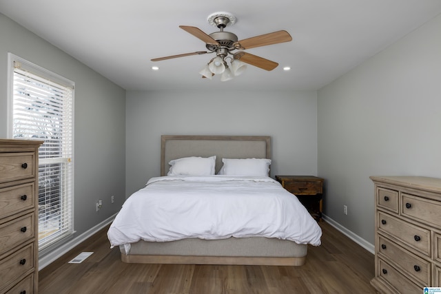 bedroom with ceiling fan and dark hardwood / wood-style flooring